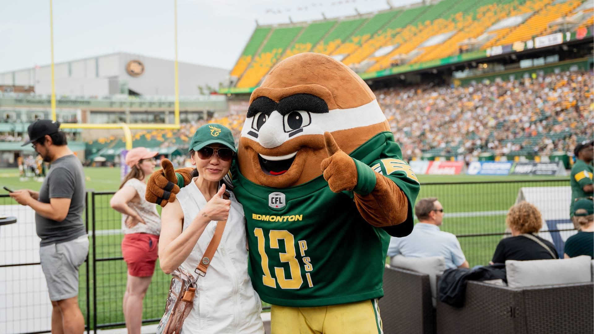 An HSAA member posing with Punter, the Edmonton Elks football mascot.