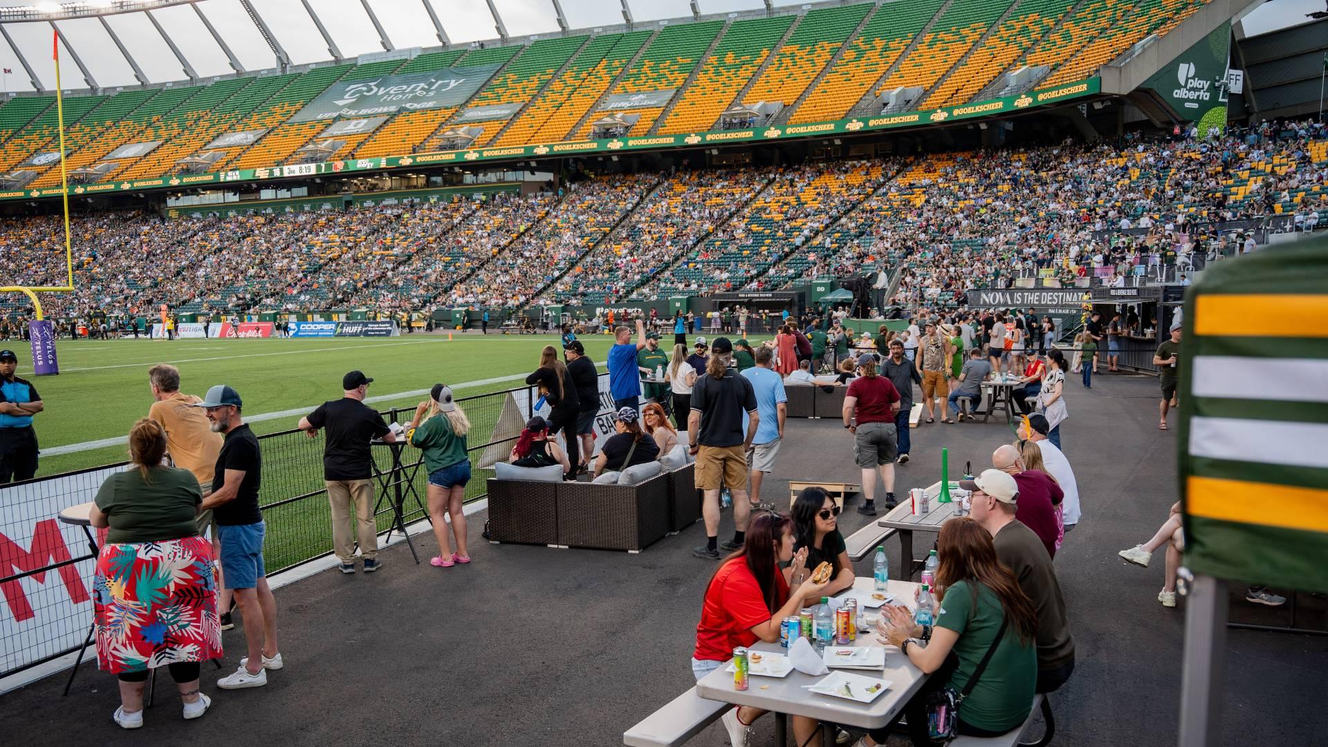 Wide shot of the HSAA members enjoying the end zone viewing area at the Edmonton Elks Football Stadium