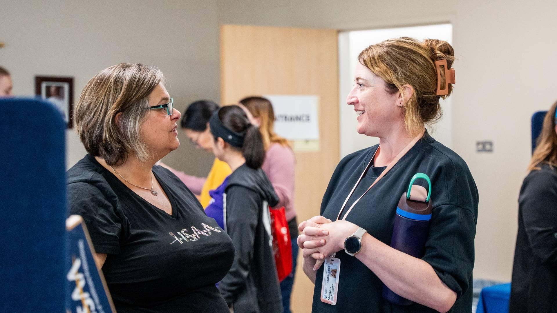 Two HSAA members talking during a site visit event.